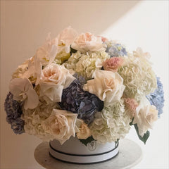 Luxury Floral Arrangement with White Roses, Hydrangeas, and Orchids in Elegant Hat Box - Rawadat Al Ward