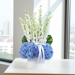 Elegant Blue Hydrangea and White Delphinium Flower Arrangement in White Hat Box